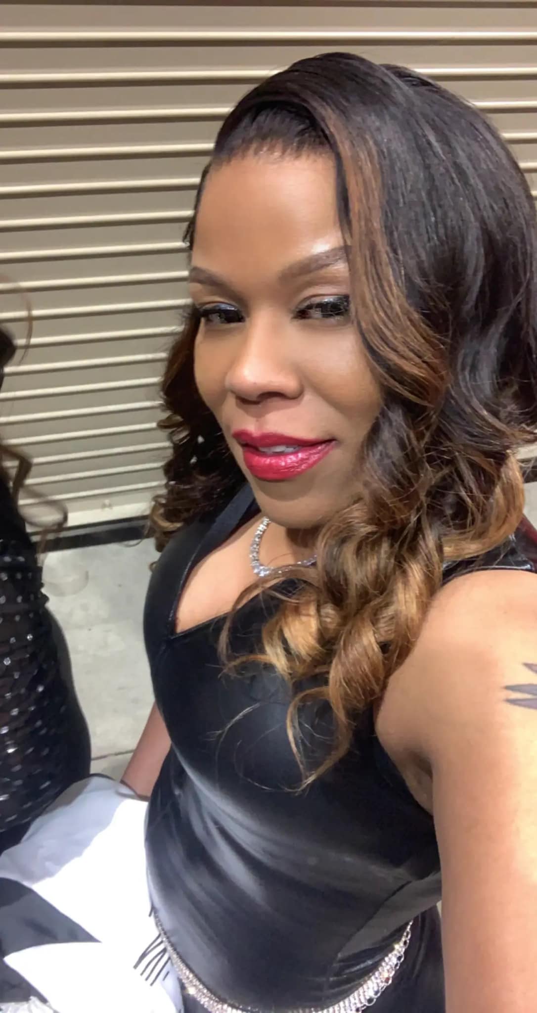 K R Raw Hair owner wearing luxury raw hair wig with soft waves, full volume, and flawless natural finish